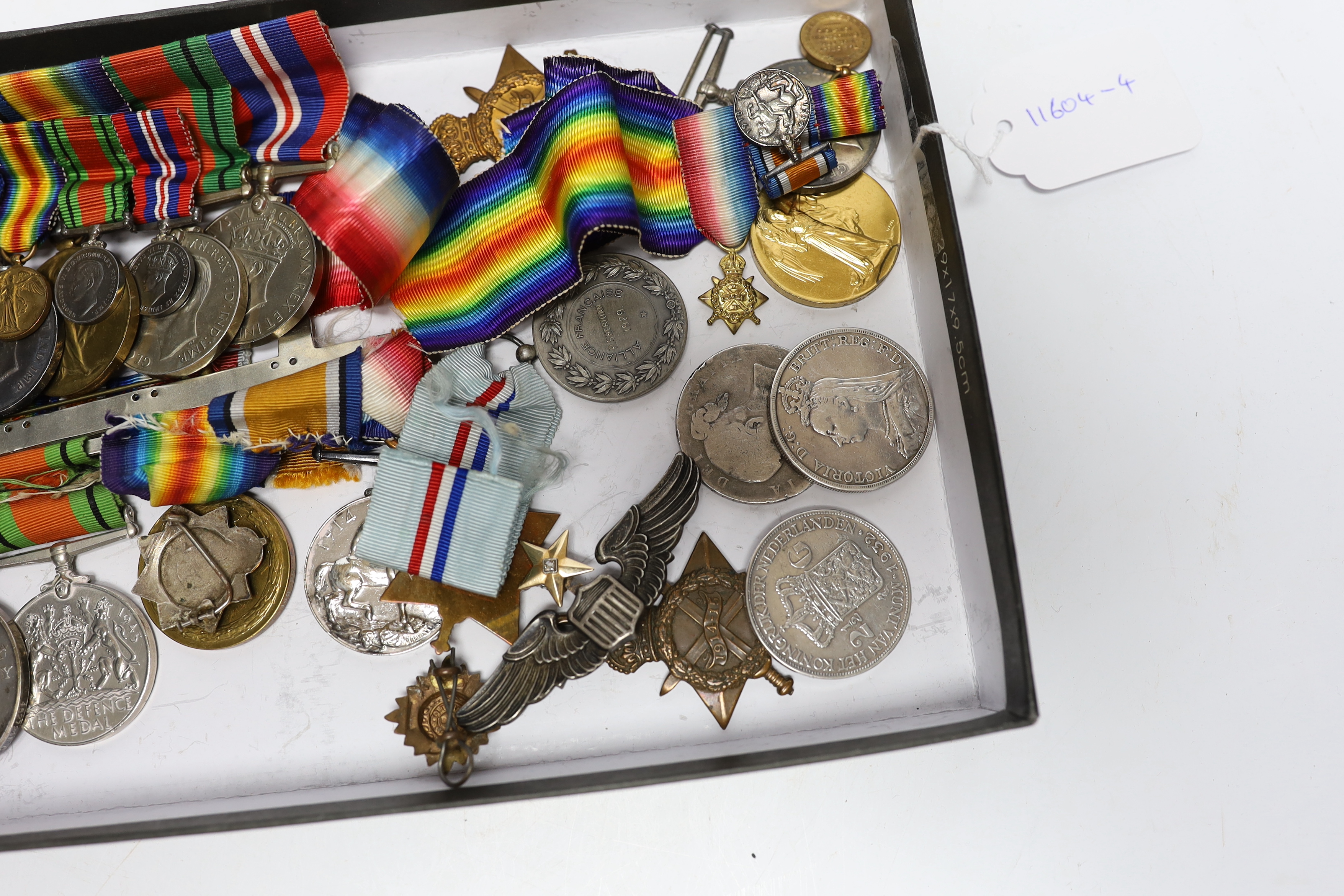 A collection of eighteen medals and some associated miniatures; a WWI/WWII group including a military MBE, WWI trio, WWII Defence and War medals to J.I.B. Farrant R.N. together with its miniature group and bar